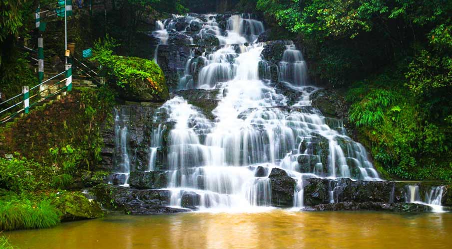 Elephant Falls in Shillong, a picturesque waterfall cascading down rocky cliffs amidst lush vegetation